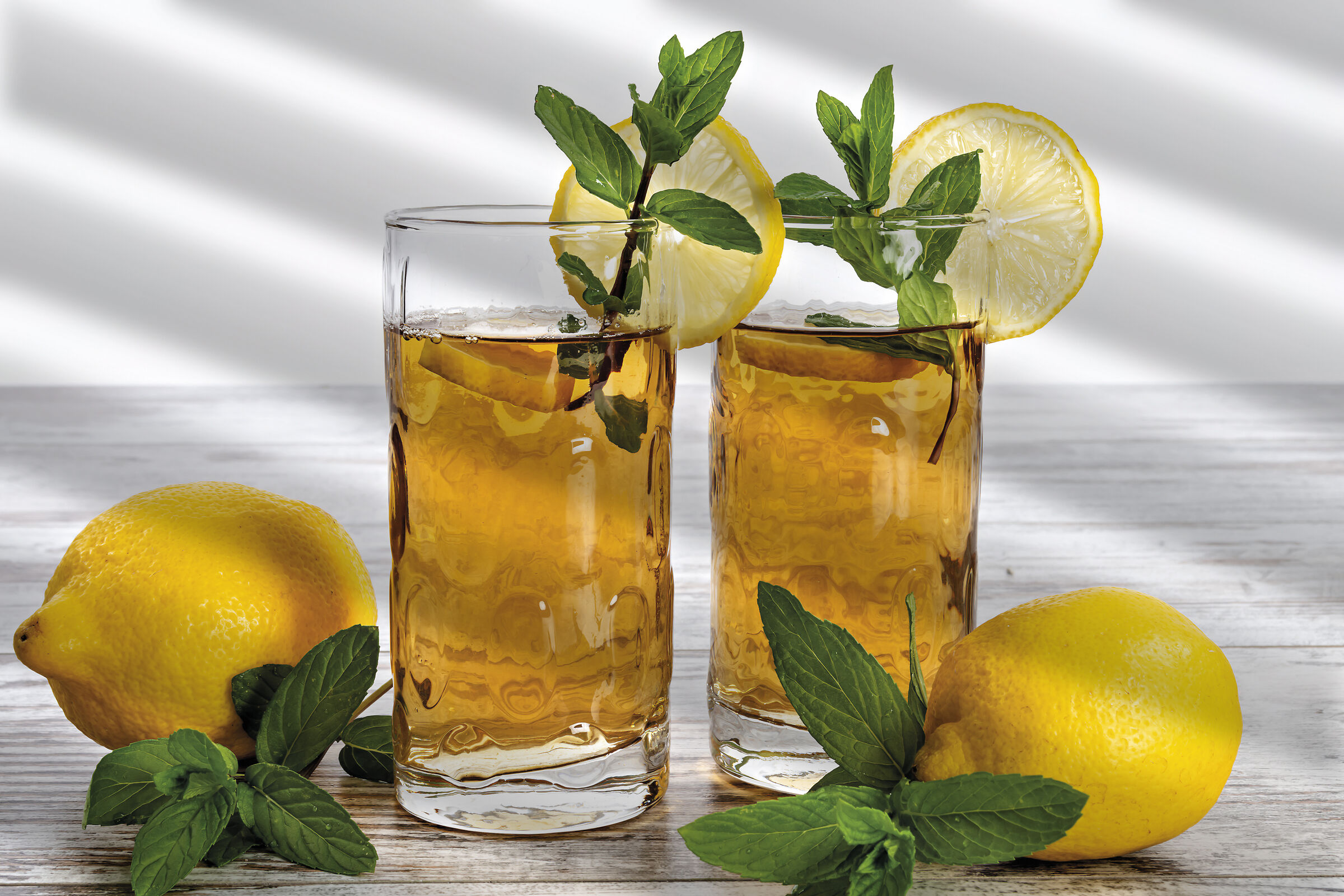 Lemon tea with mint two glasses front...