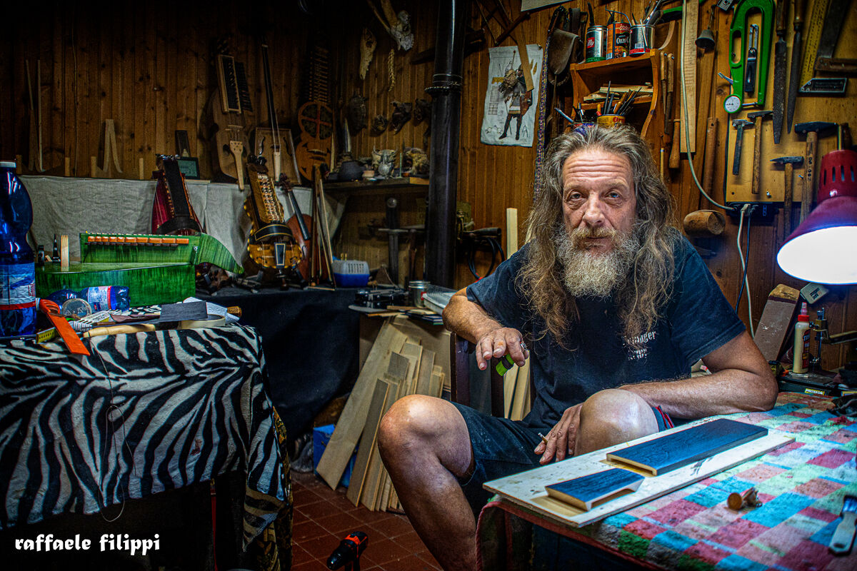 Portrait of Sergio master violin maker, in his workshop ...