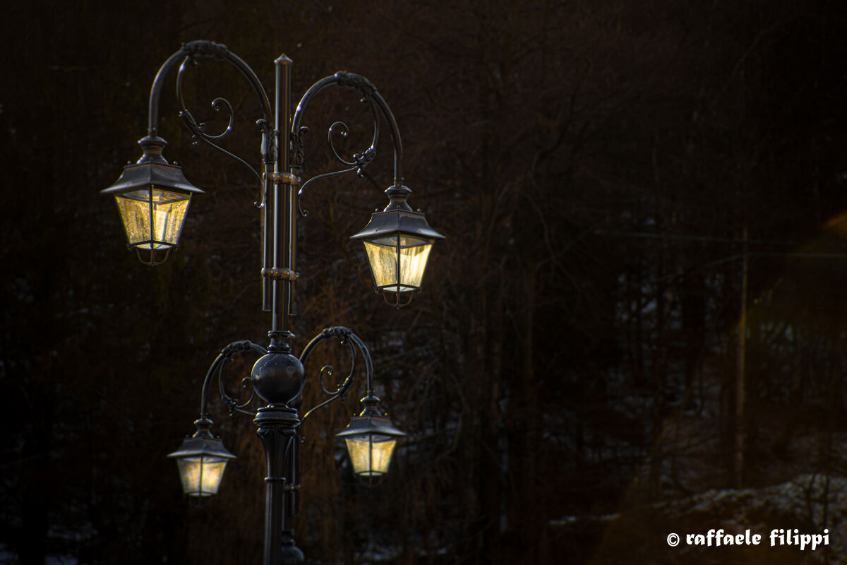 Last rays of light on the lampposts of Oropa - Biellese...