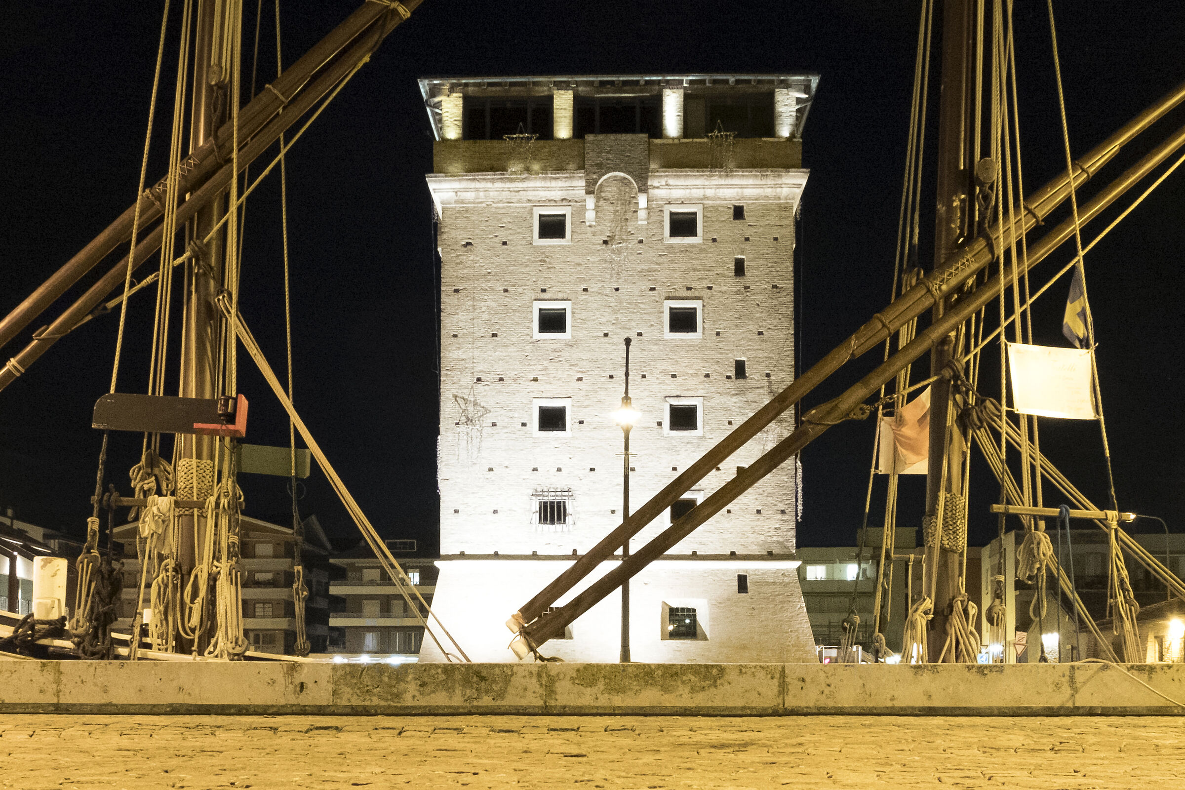the tower framed by the trees of a boat...