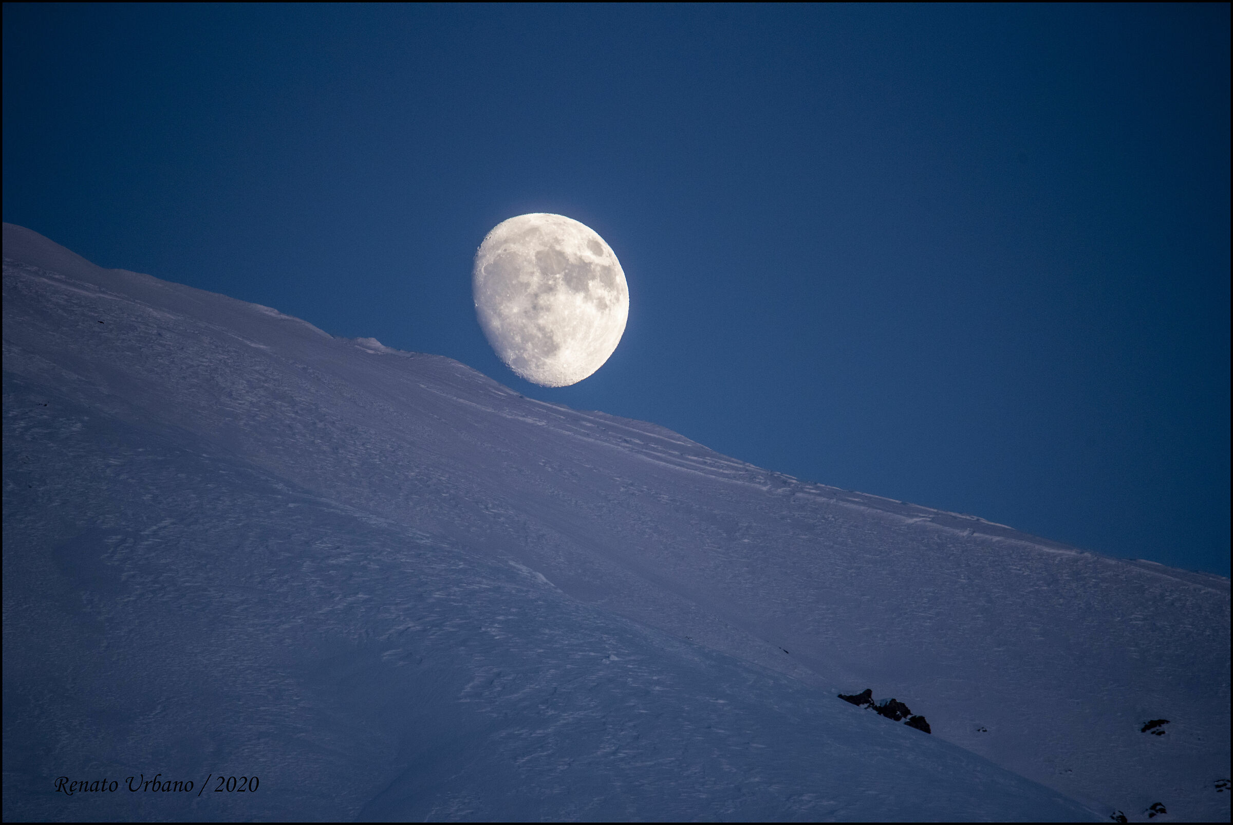 The moon emerges from the mountain...