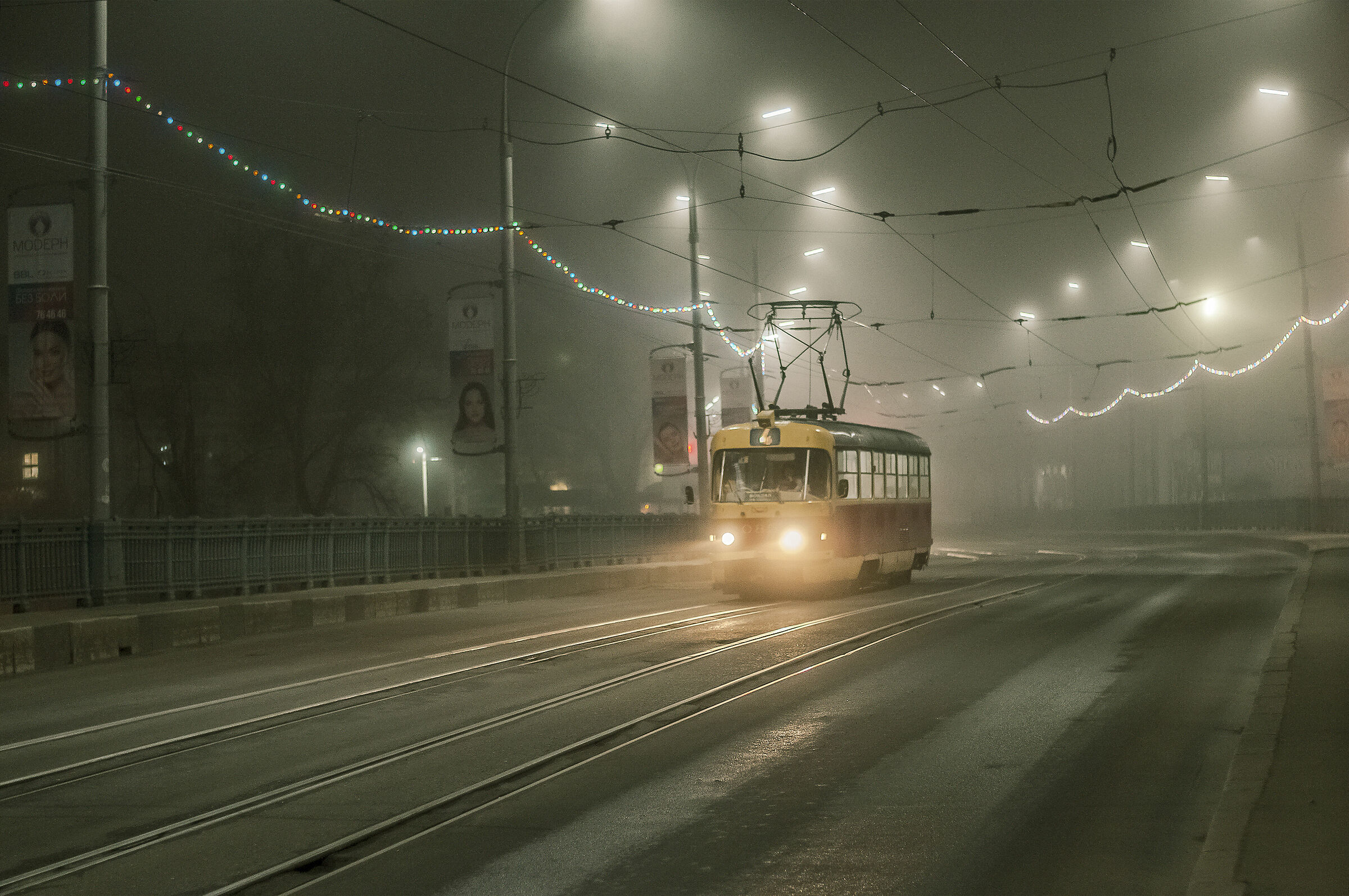 An old cable car on a night trip through a foggy city.....