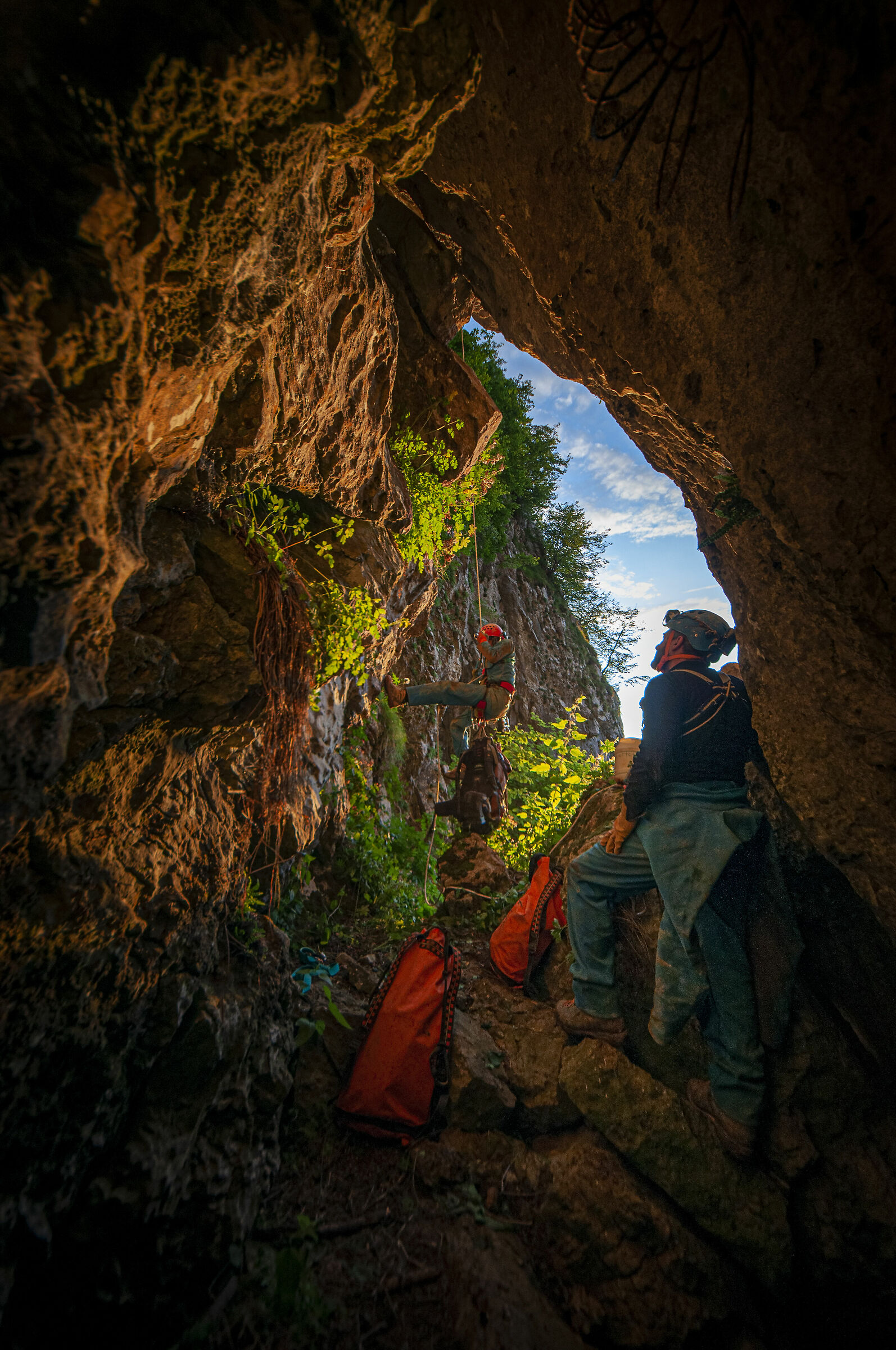 Improvviso - entrance with caver climbing out...