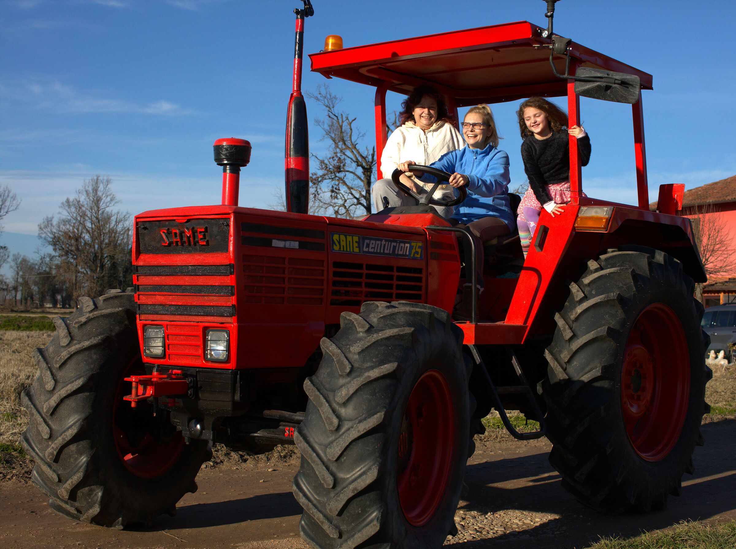 Girls have fun with president's tractor...