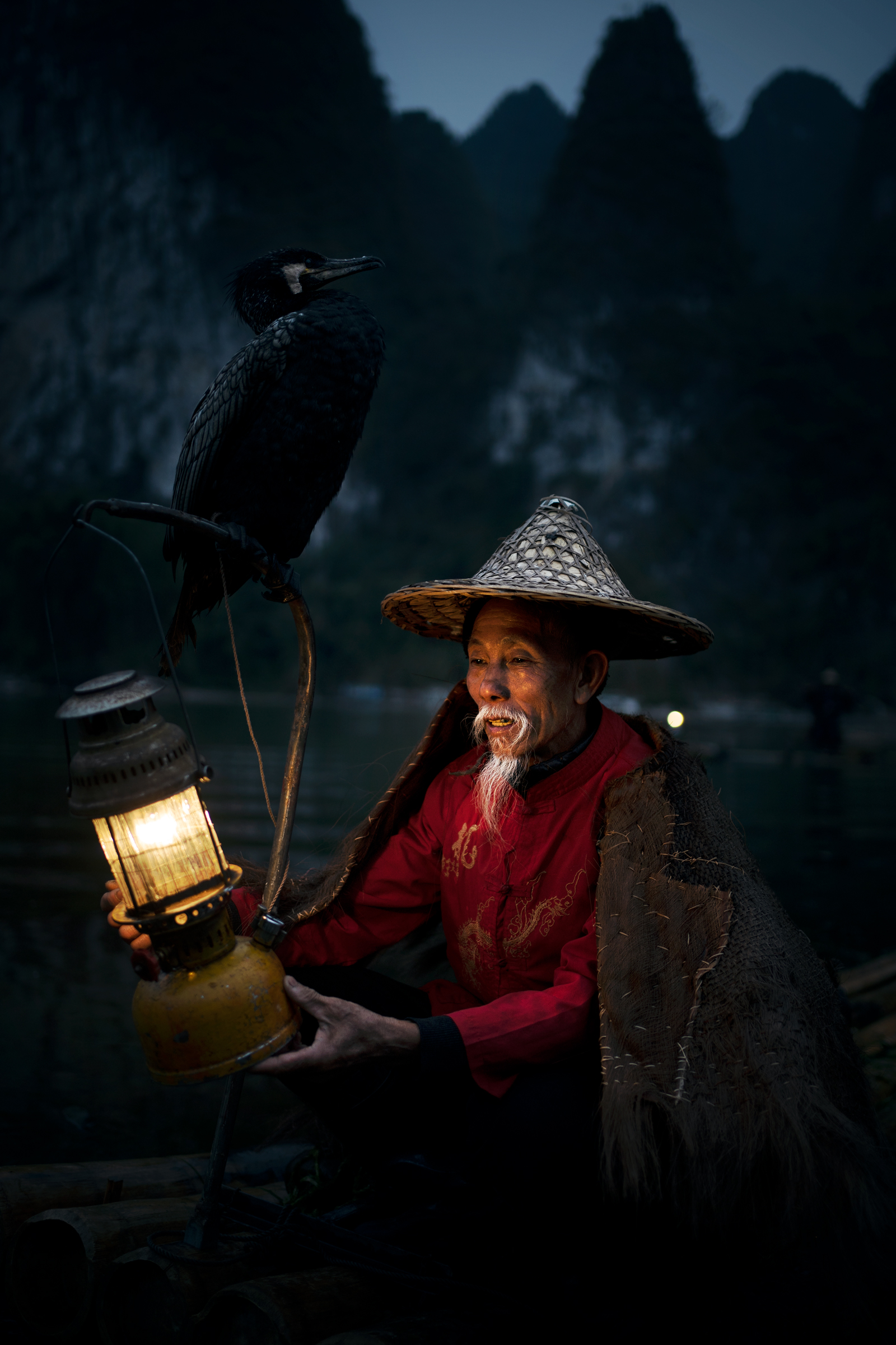 China 2020. Fisherman with cormorant...